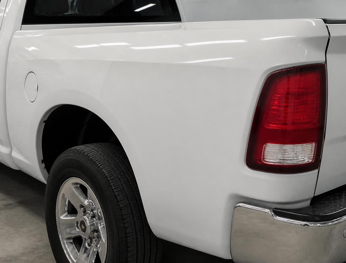 Completed hail repair with original factory paint — Truck bedside — deep dents